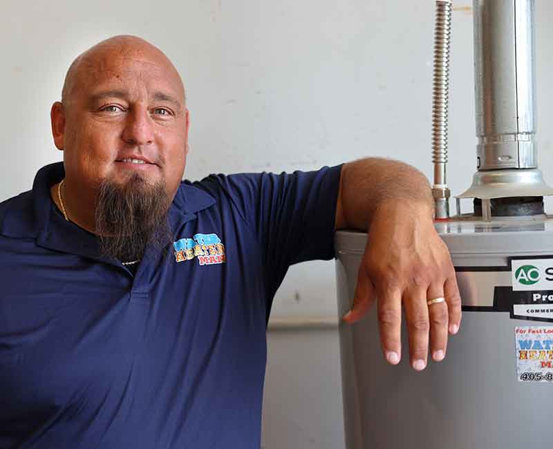 darryl owner of water heater man standing next to a water heater new installation