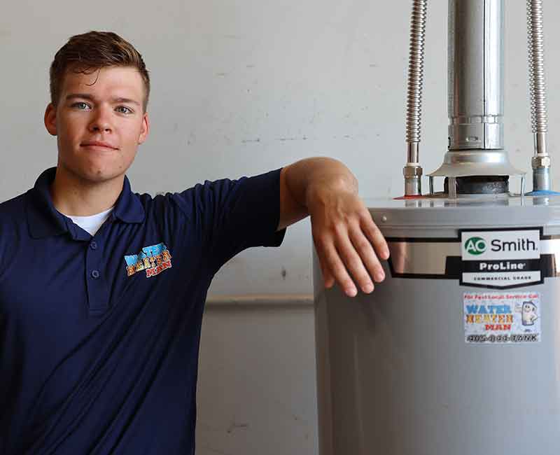 water heater man technician standing next to new water heater
